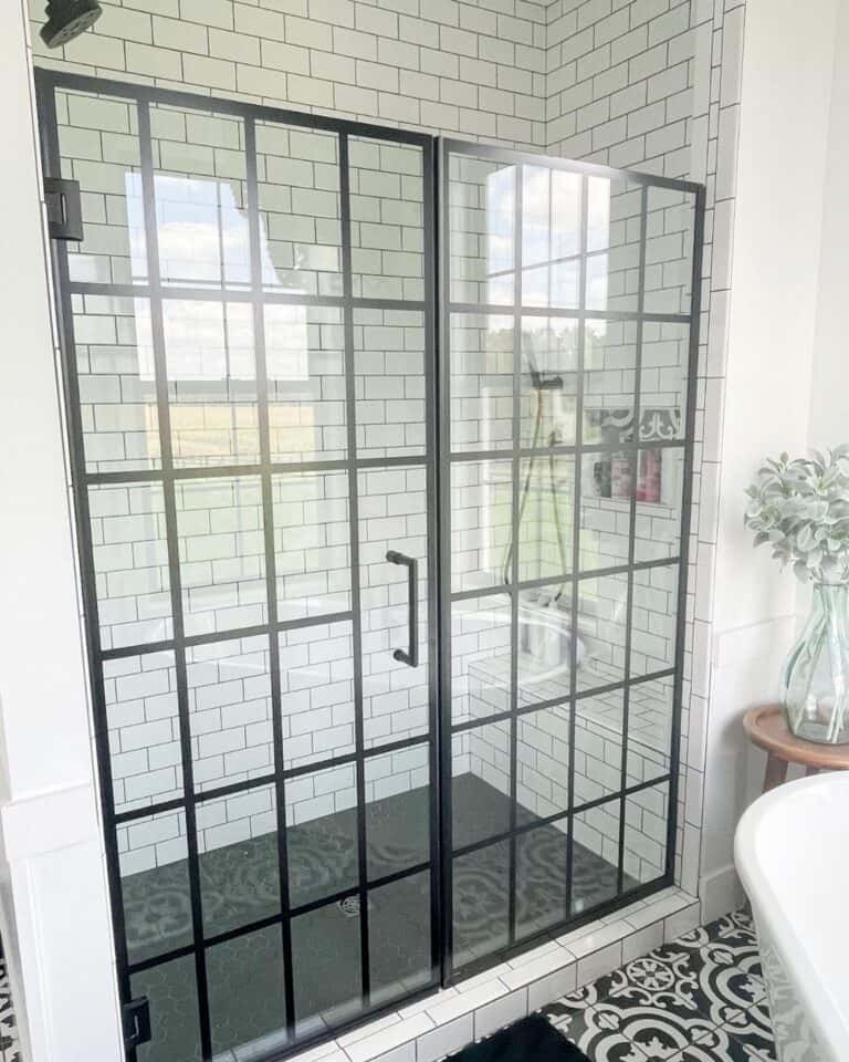 Well Lit Bathroom with Black Shower Door