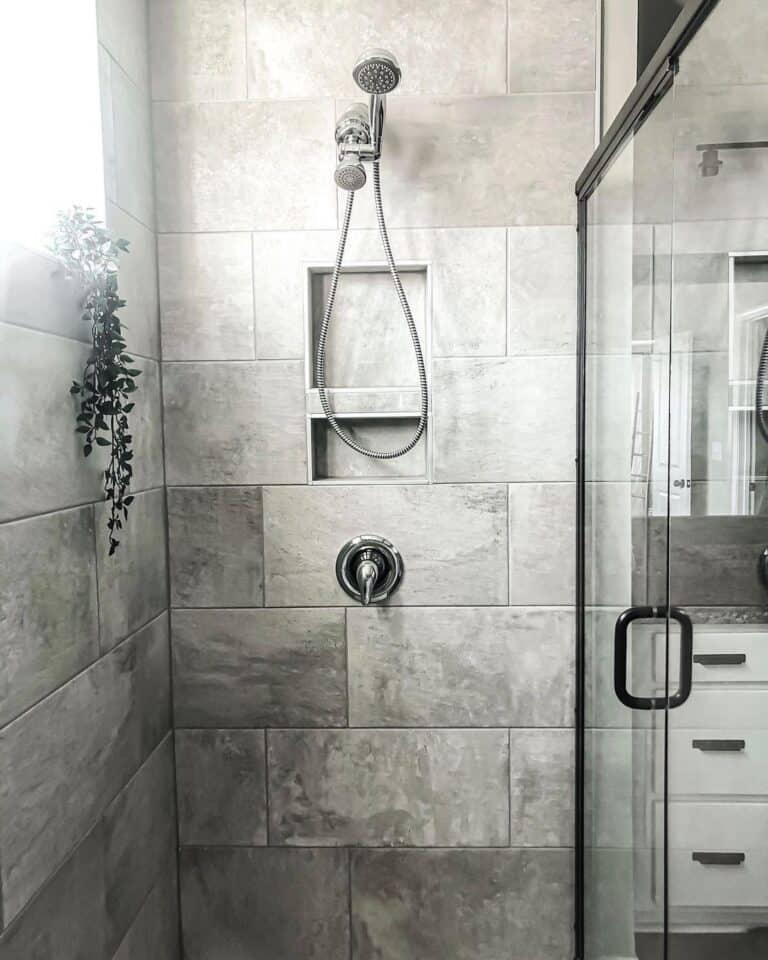 Plant Hanging Over Large Grey Bathroom Tiles