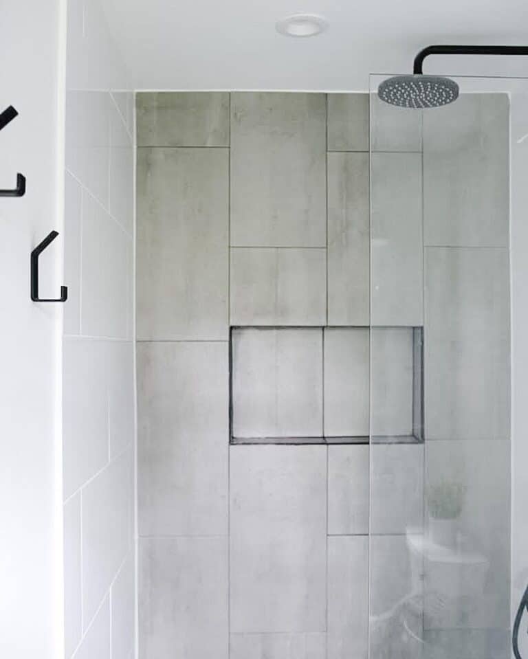 Black Faucet with Large Tiles for Shower Walls