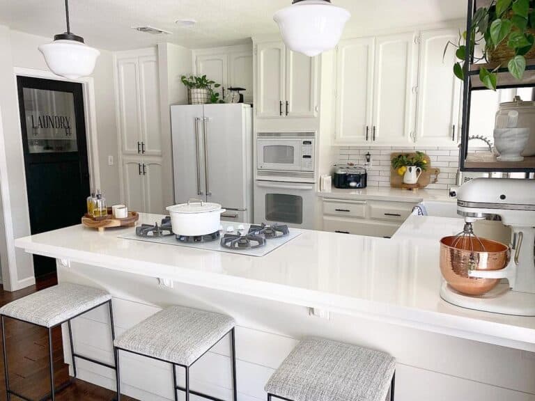 Grey Barstools Under a U Shaped Kitchen Peninsula