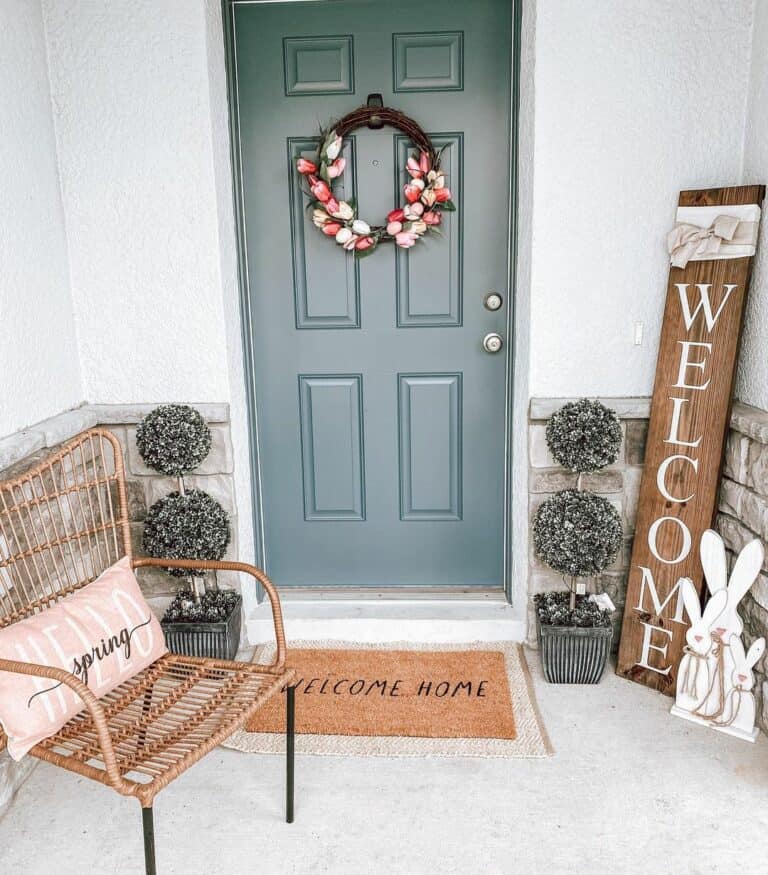 Faux Topiaries Sit Beside a Forest Green Door