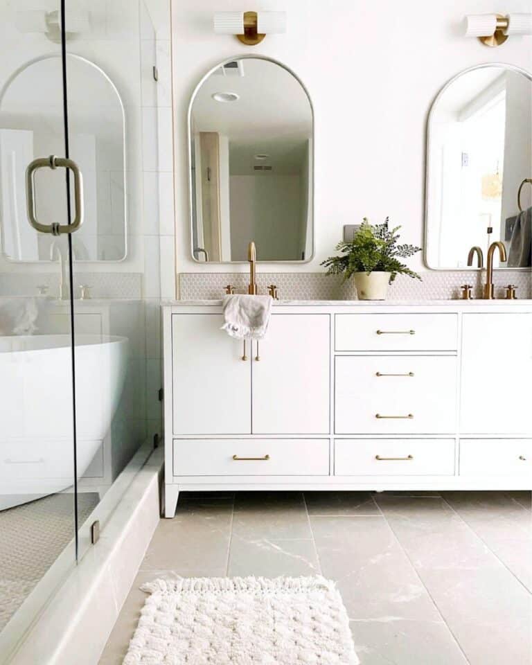 Angled Stone Shower Curb in Neutral Bathroom
