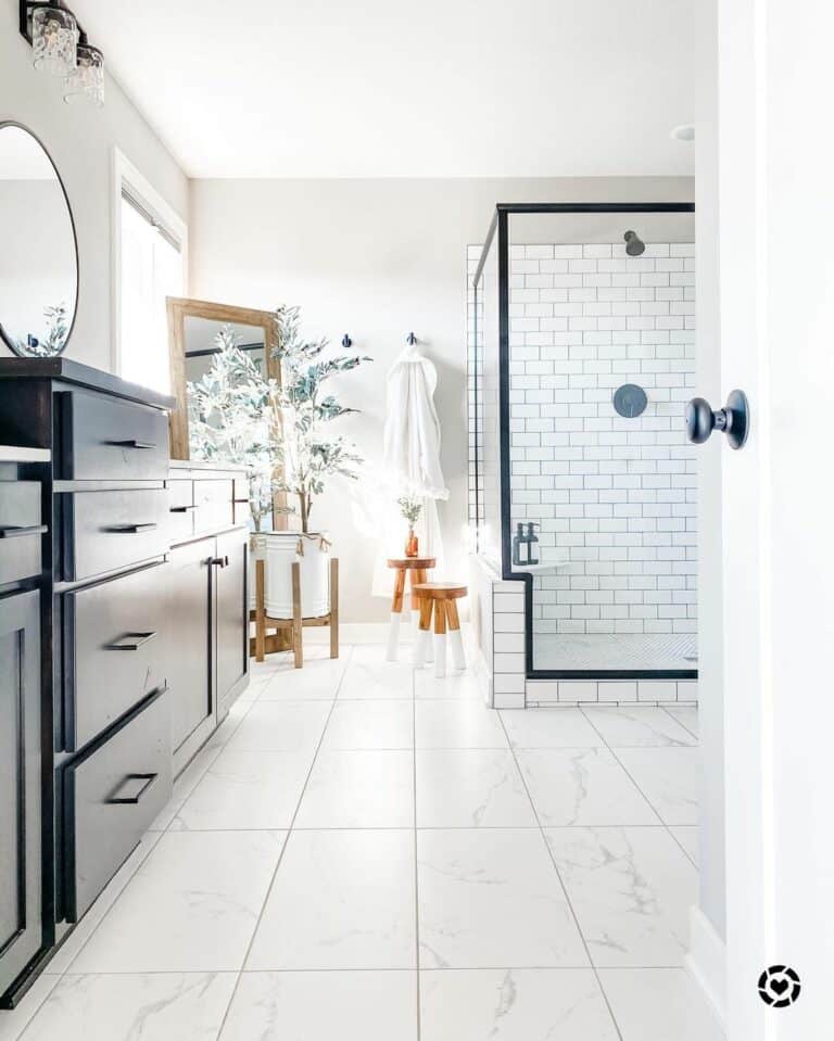 White Tile Shower Threshold and Dark Painted Vanity