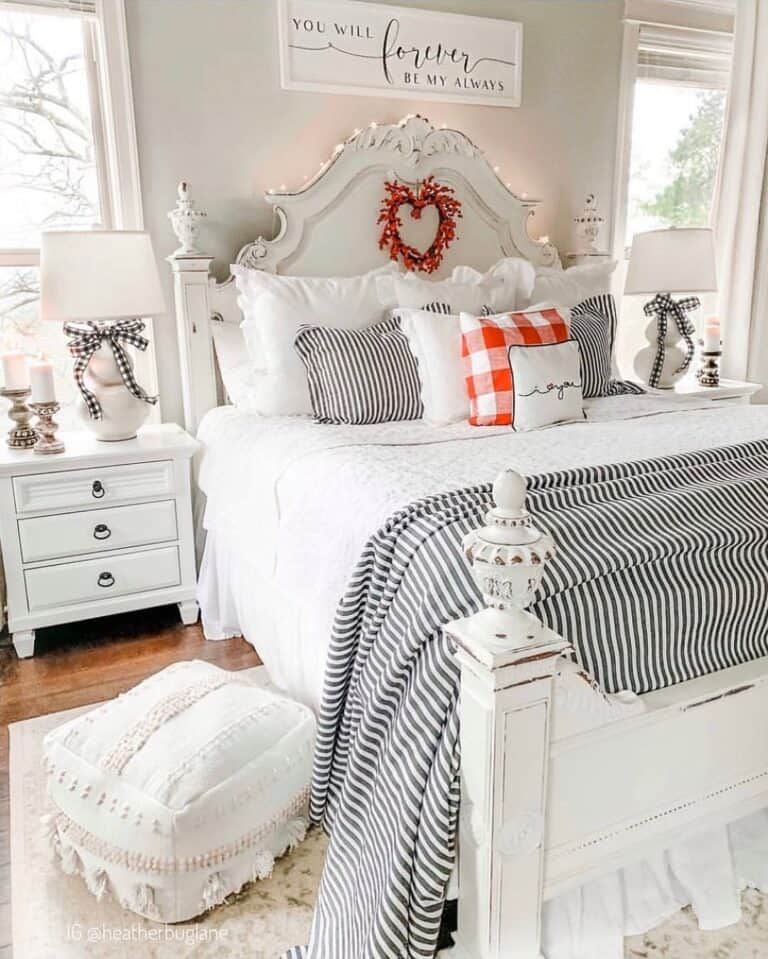 White Foot Pouf Near a Black and White Striped Coverlet