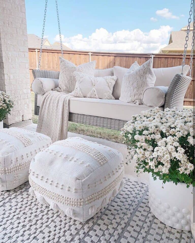 Two White Floor Poufs Between Large Planters