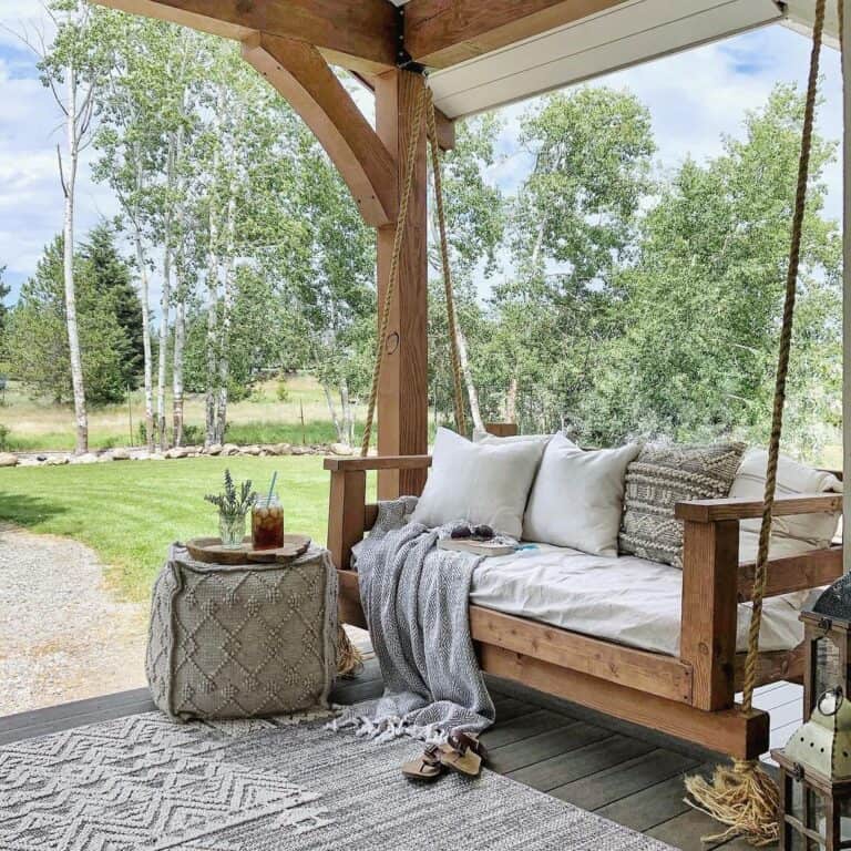 Large Grey Pouf Ottoman Near a Porch Swing