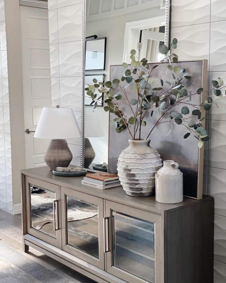 Wooden Console Table Against a Textured White Tile Wall