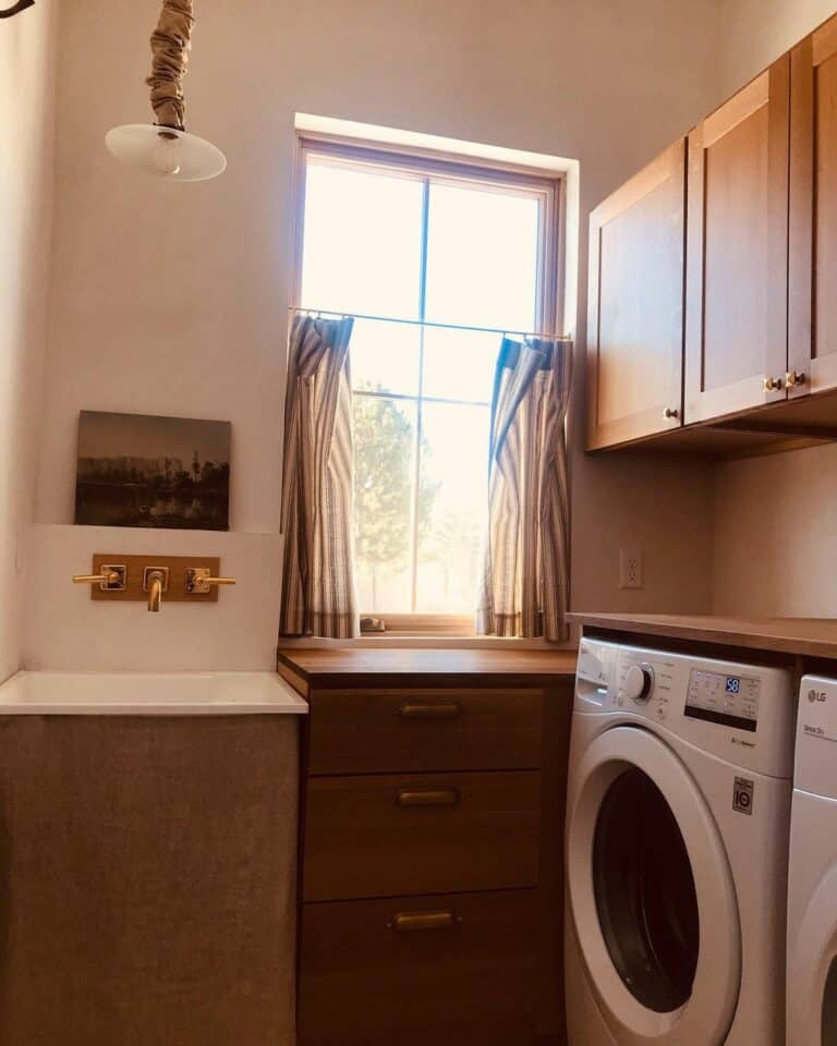 Stained Wood Laundry Cabinets With Brass Hardware