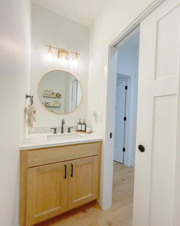 Powder Room With Wooden and Gold Elements