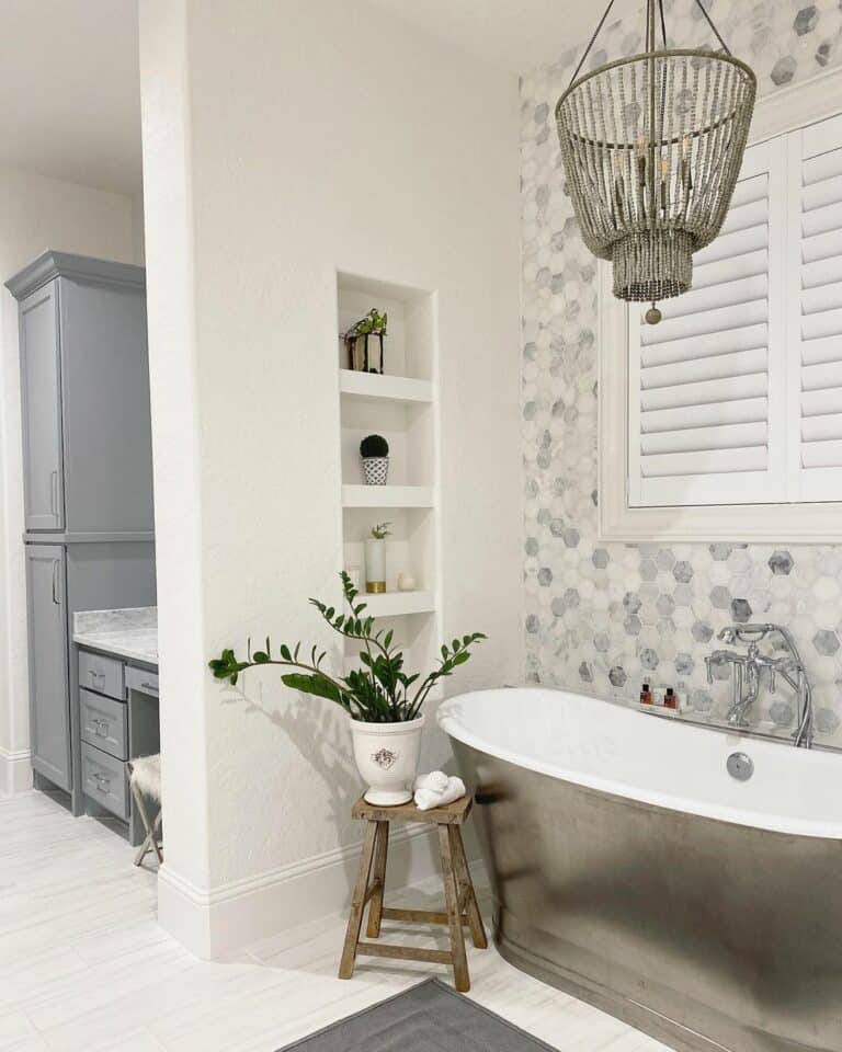 Steel Bathtub Beside Mosaic Bathroom Wall