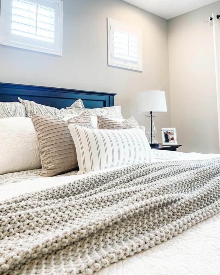 Light Grey Blanket Draped Over a White Coverlet