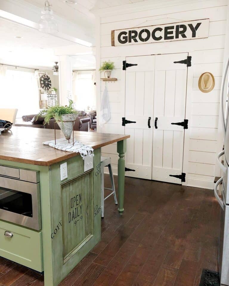 Green Kitchen Island and White Farmhouse Pantry