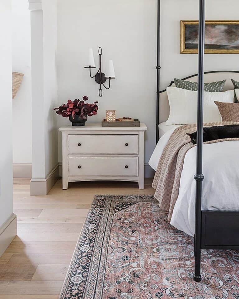Black Sconce Over a Wide White Nightstand