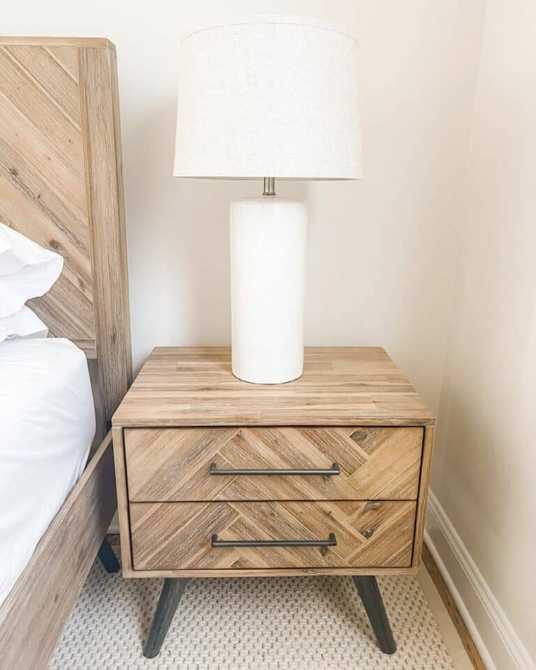 White Lamp on a Natural Wood Herringbone Nightstand