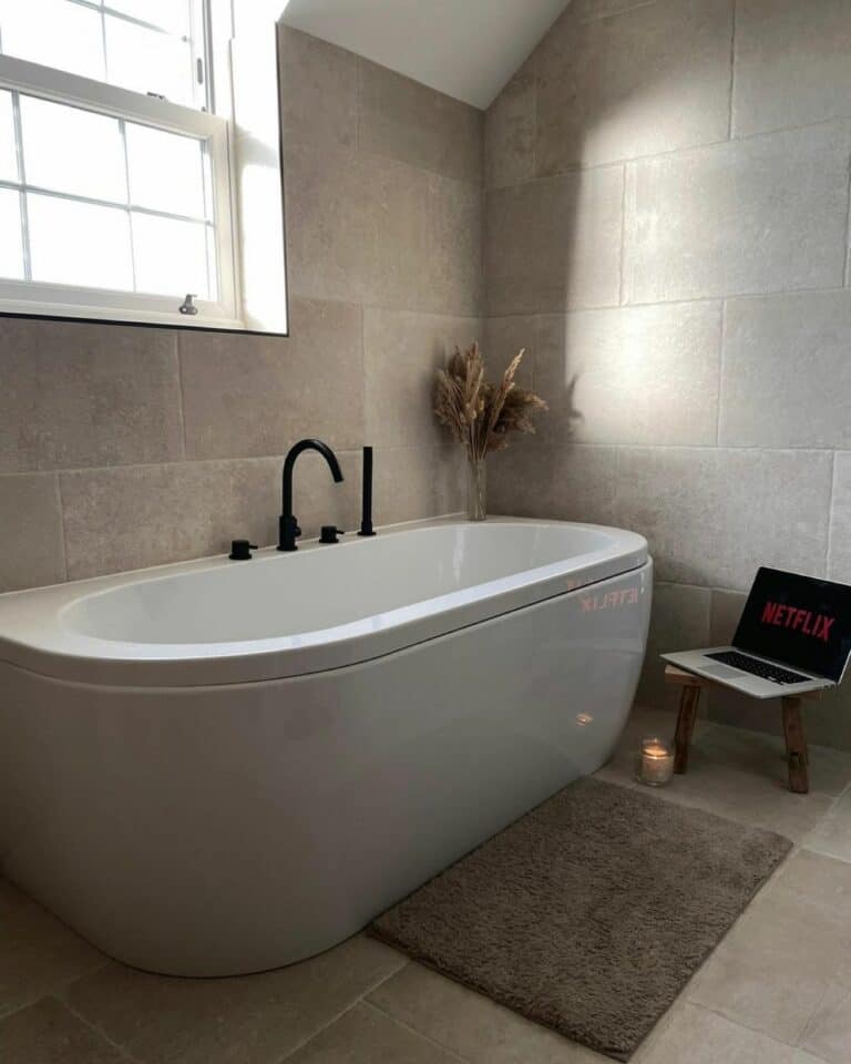 Gray Tile Covers Bathroom Walls and Floor