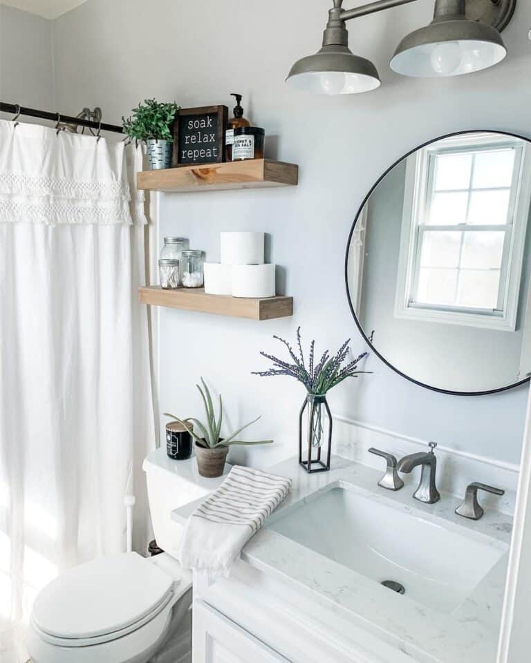 White Bathroom with Circular Black Mirror