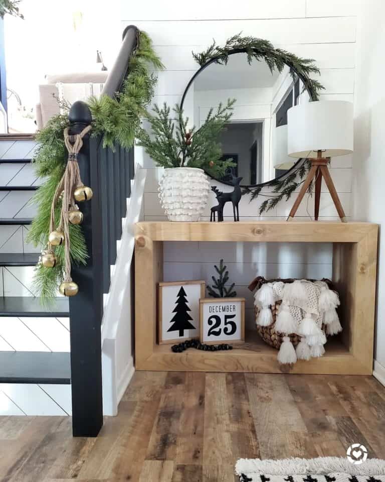 Garland With Gold Bells on Black Staircase Railing