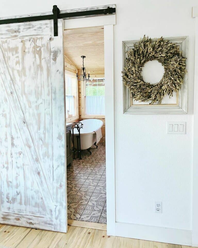 Barn Door Opened To Reveal Farmhouse Bathroom