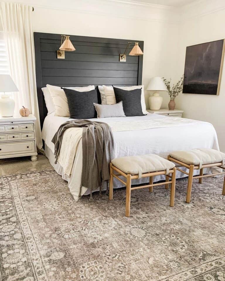 Black and White Bedroom With a Large Black Headboard