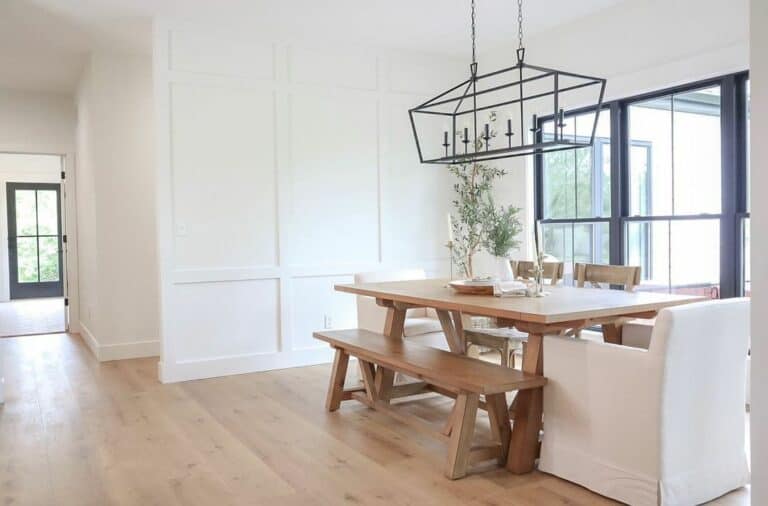 Large Armchairs and a Light Wood Bench at a Dining Room Table