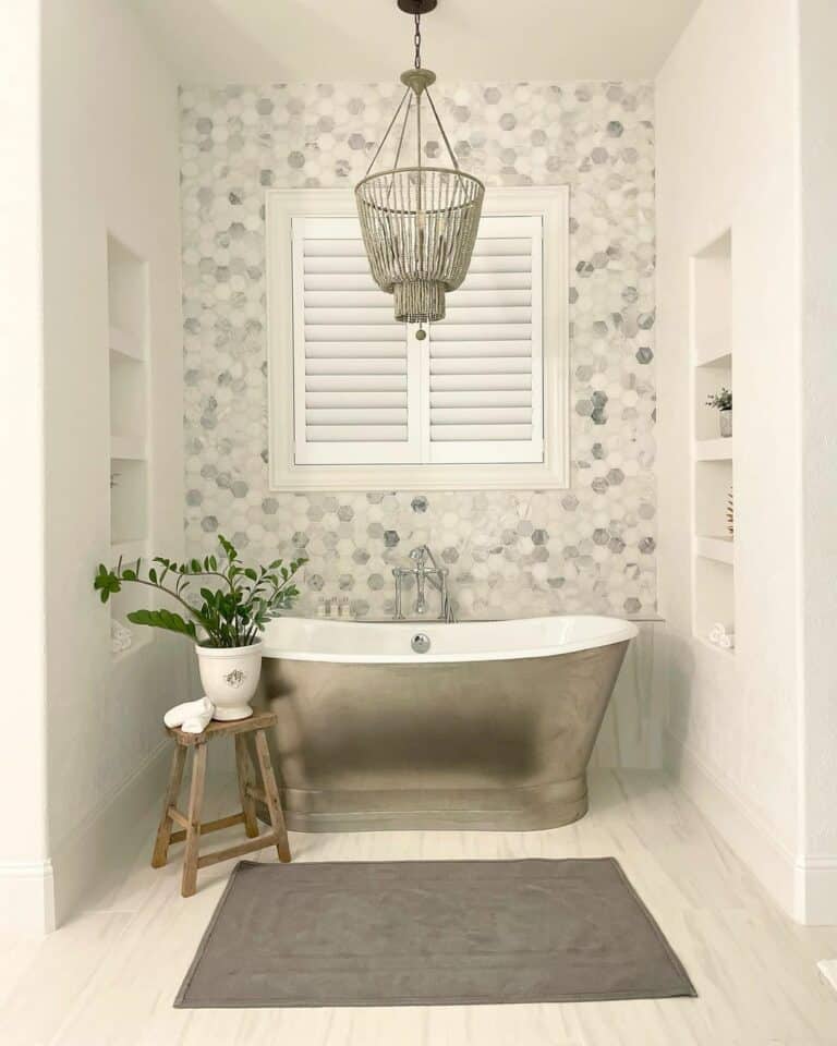 Luxury Master Bathroom With a Metallic Freestanding Bath