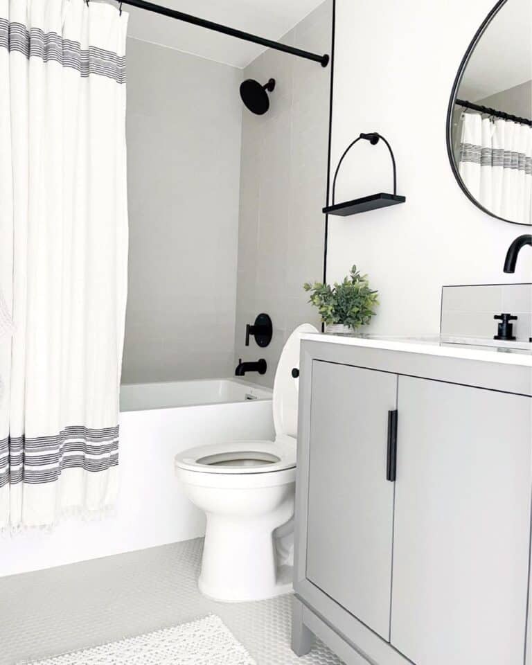 Black Shower Head and Handle on a Light Grey Shower Wall