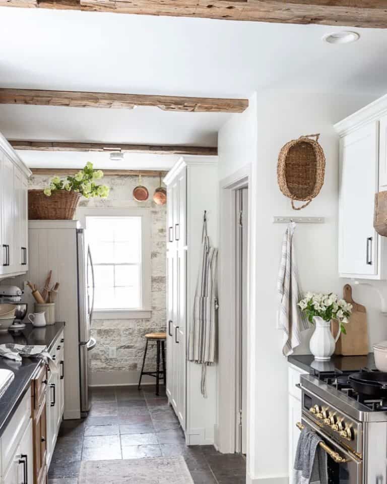 Wood Beam Kitchen with White Stone Wall