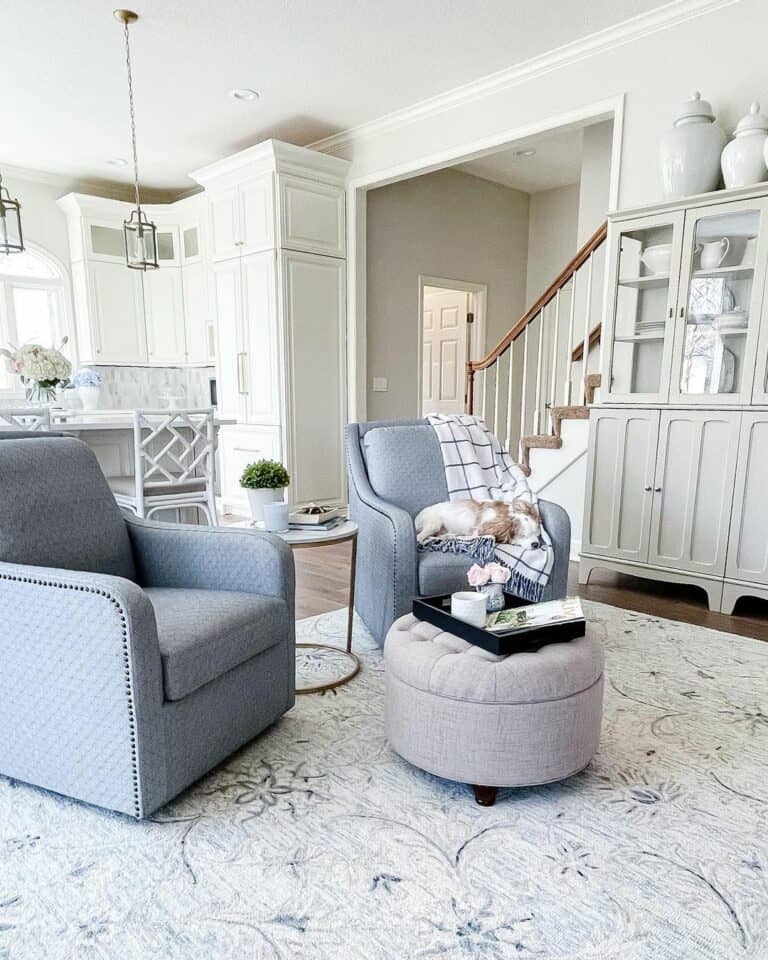 White Kitchen With Gray Chairs and Pouf