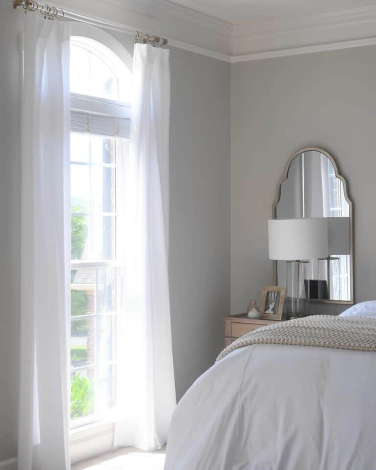 Mirror Behind Nightstand Against Gray Wall