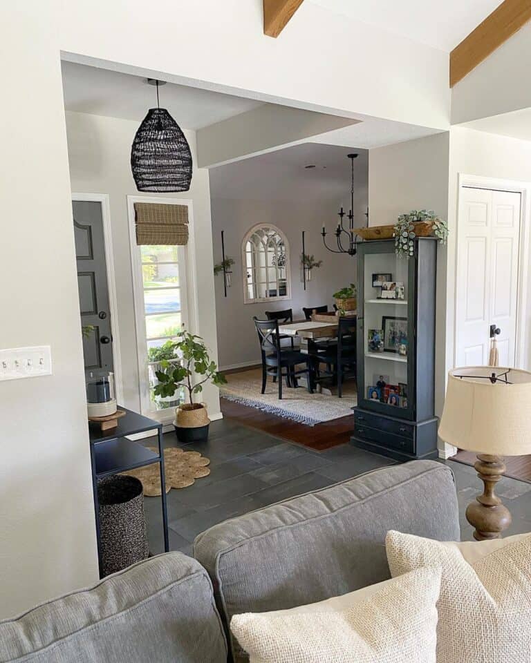 Black Rattan Hanging Lamp Over a Dark Wood Floor