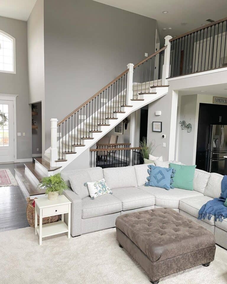 Beige Carpeted Staircase with White Stair Skirt Board